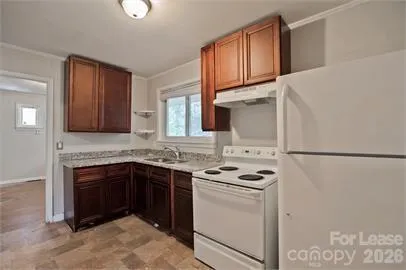 a kitchen with stainless steel appliances granite countertop a stove sink and refrigerator