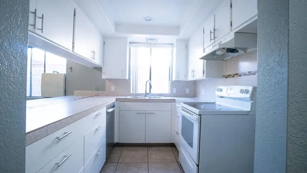 a kitchen with a sink stove and cabinets