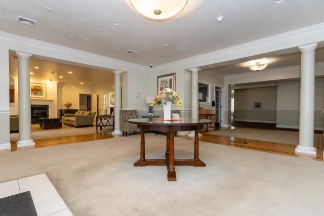 a living room with furniture a rug and a window