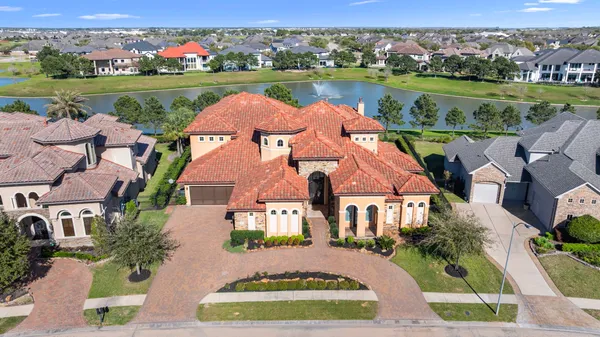 a aerial view of a house with swimming pool and furniture