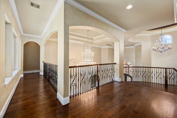 a living room with furniture pool table wooden floor and a rug