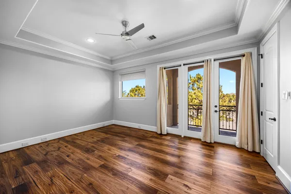a room with pool table ceiling fan and windows