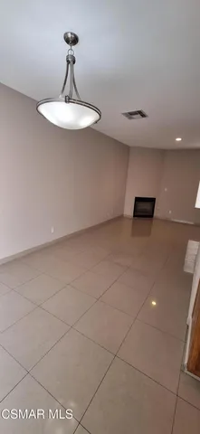 a view of a room with a sink and chandelier