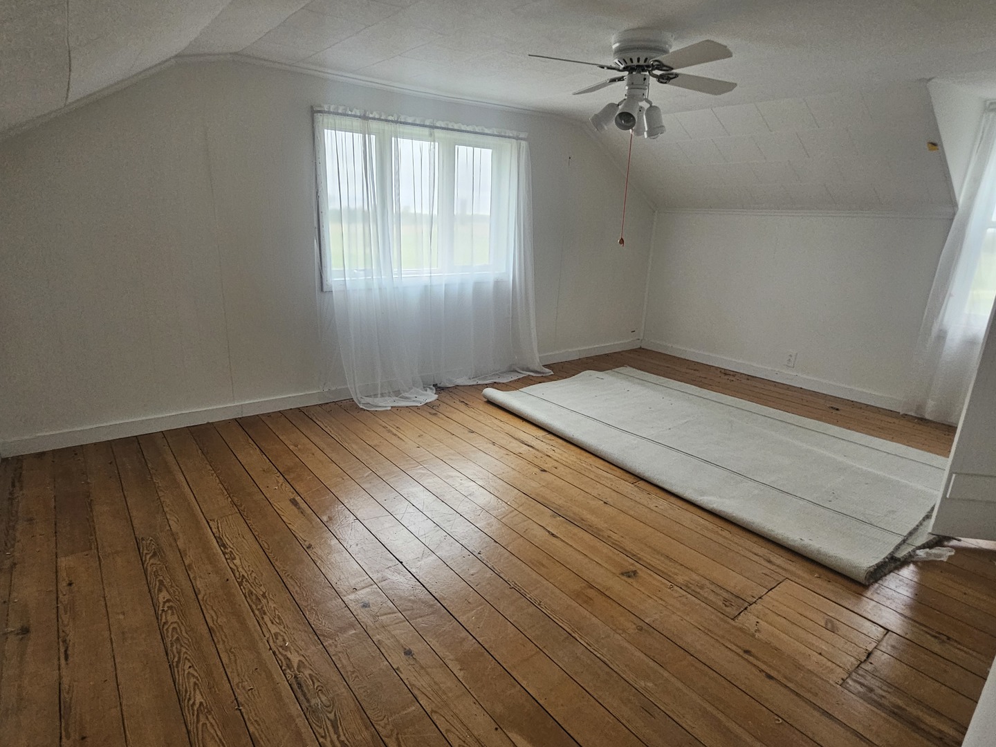 23018 Freeport Road Sterling, IL 61081 - Photo 11 of 19 a view of empty room with wooden floor and fan