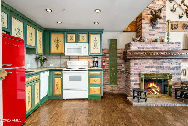 a kitchen with stainless steel appliances granite countertop a stove and a fireplace