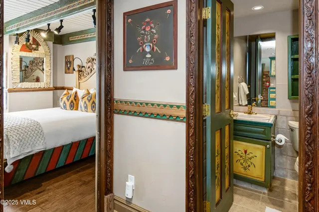 a bedroom with a bed and a painting on the wall