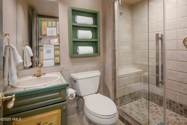 a bathroom with a sink toilet and shower