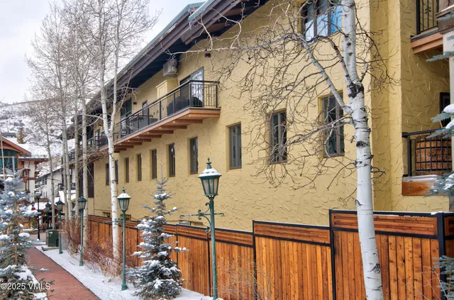 a view of a brick house with many windows