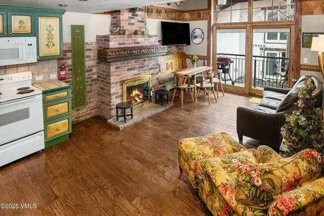 a living room with furniture a flat screen tv and a floor to ceiling window