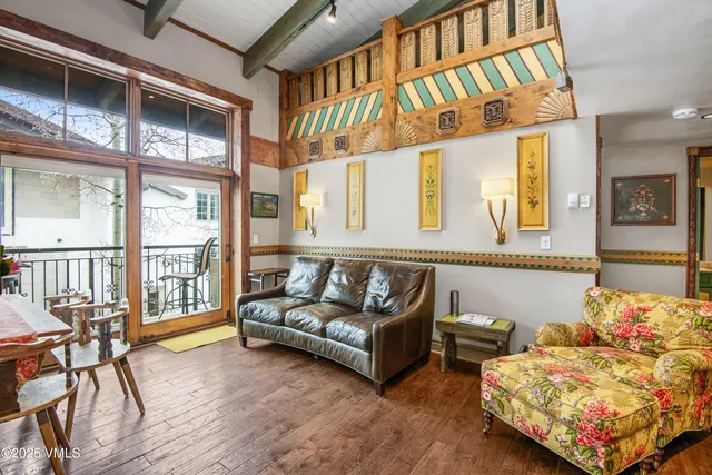 a living room with furniture staircase and a dining table