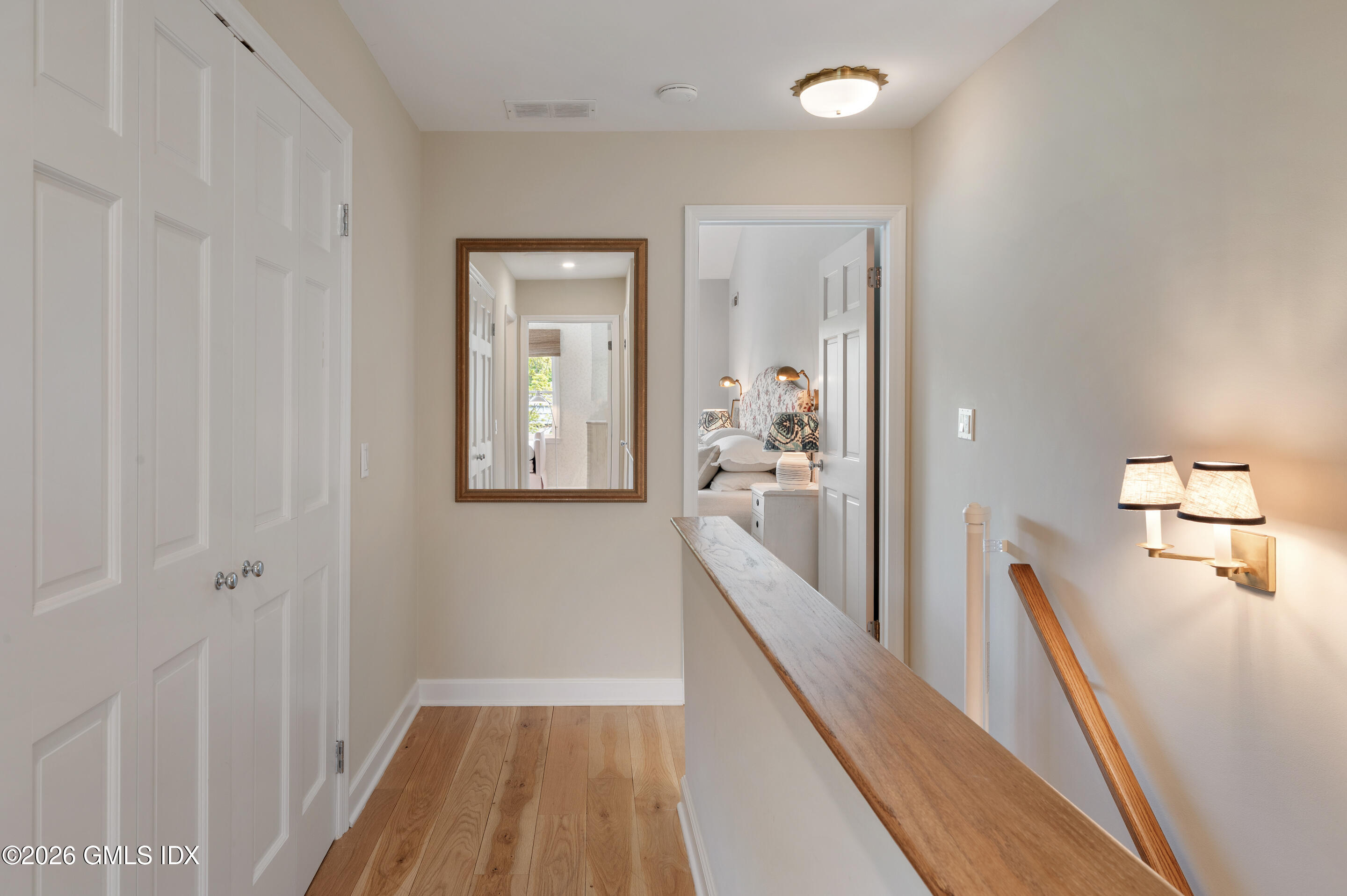 115 River Road, Unit 3 Cos Cob, CT 06807 - Photo 17 of 40 a view of a hallway with wooden floor and staircase