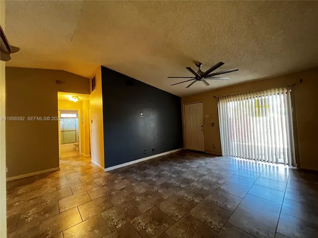 a view of a livingroom with a hall and wooden floor