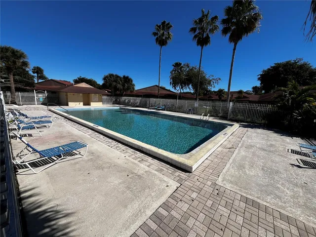 a view of a backyard with a tub and trees in the background