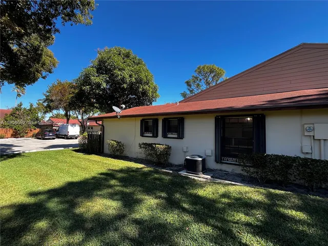 a view of a backyard with table and chairs under an umbrella