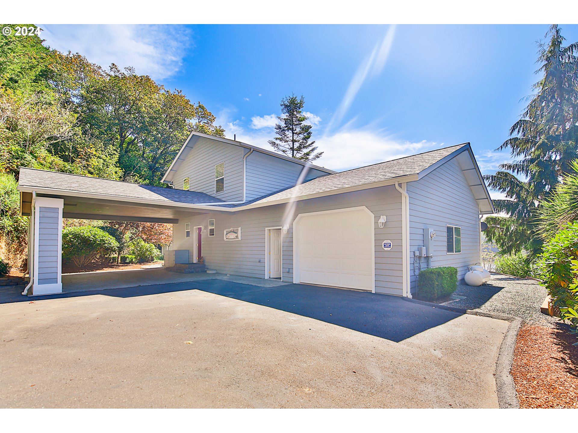 311 Council Hill Road Lakeside, OR 97449 - Photo 12 of 42 a view of a house with a yard and potted plants