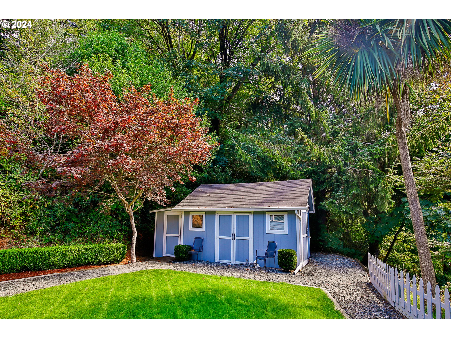 311 Council Hill Road Lakeside, OR 97449 - Photo 17 of 42 a view of a big house with a big yard plants and large trees