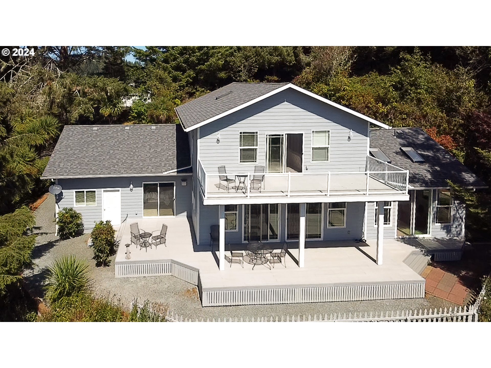 311 Council Hill Road Lakeside, OR 97449 - Photo 2 of 42 a front view of a house with a yard