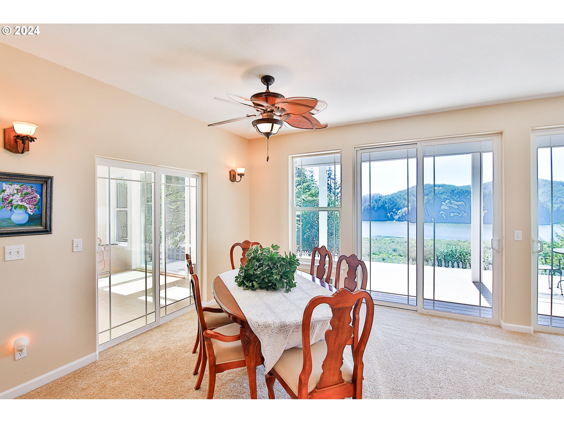 311 Council Hill Road Lakeside, OR 97449 - Photo 23 of 42 a dining room with furniture a chandelier and wooden floor