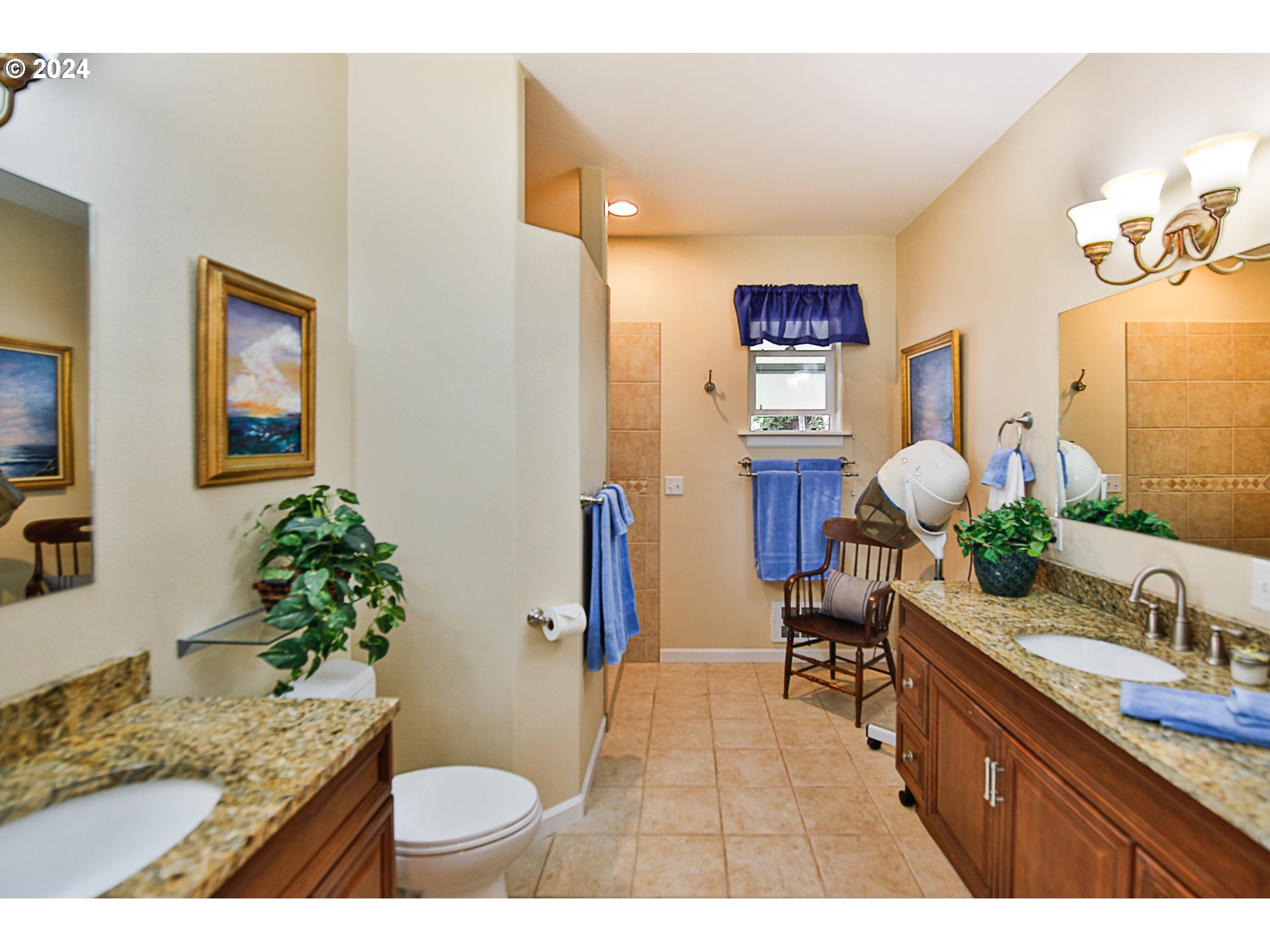 311 Council Hill Road Lakeside, OR 97449 - Photo 25 of 42 a bathroom with a granite countertop sink a toilet and mirror