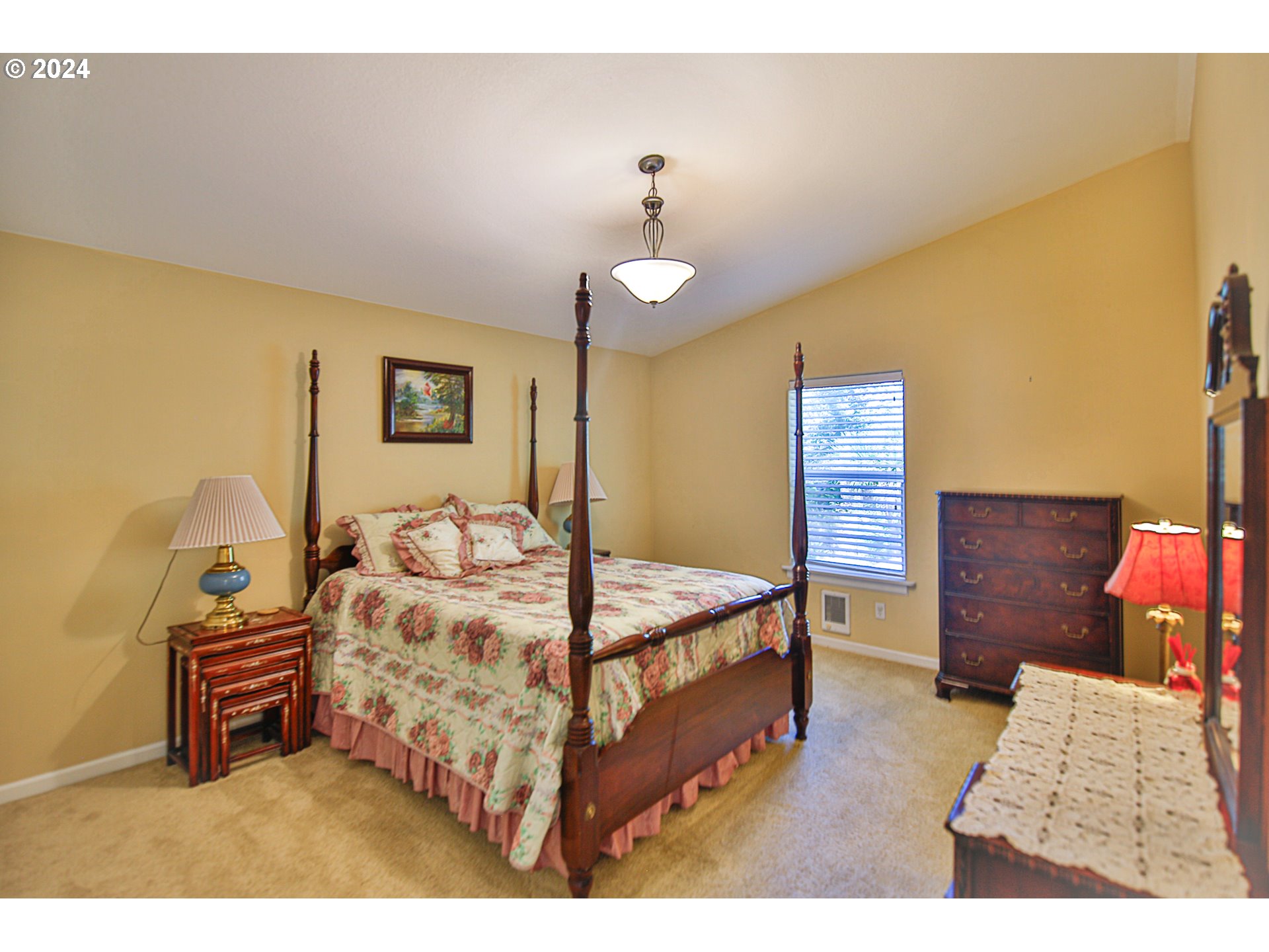 311 Council Hill Road Lakeside, OR 97449 - Photo 38 of 42 a bedroom with a bed and a chandelier