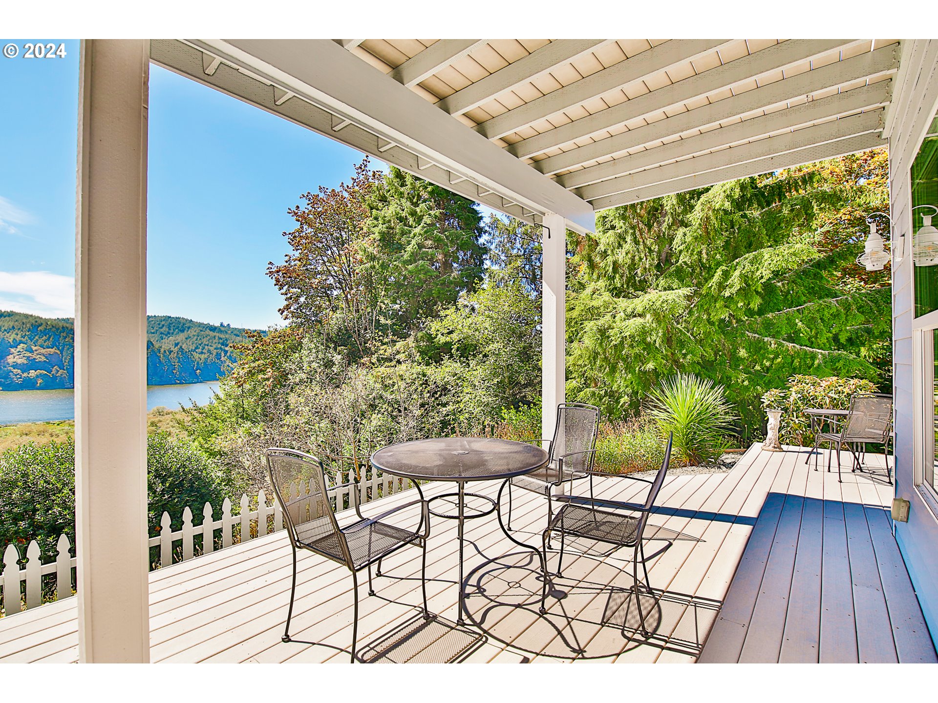 311 Council Hill Road Lakeside, OR 97449 - Photo 5 of 42 a view of a chairs and table in patio with wooden floor