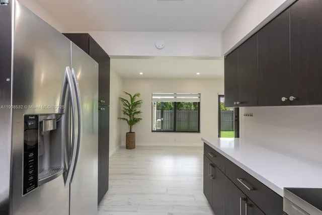 a kitchen with stainless steel appliances a refrigerator and a sink