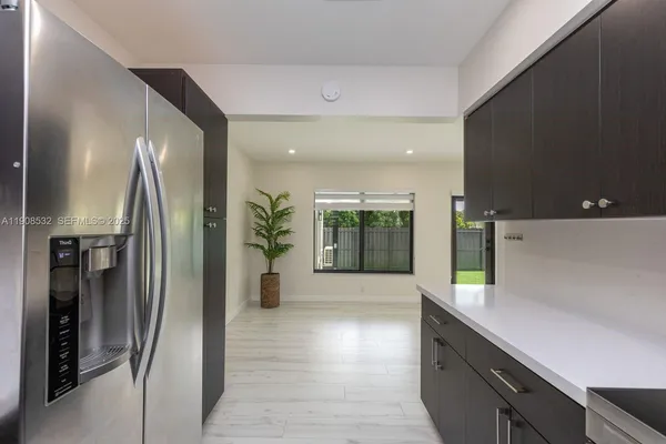 a kitchen with stainless steel appliances a refrigerator and a sink
