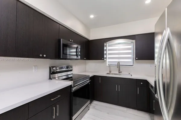 a kitchen with a sink and a refrigerator