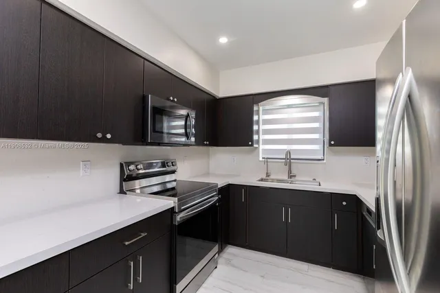 a kitchen with a sink and a refrigerator