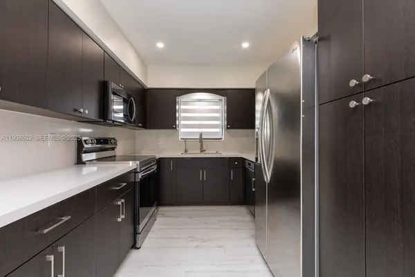 a kitchen with stainless steel appliances granite countertop refrigerator a sink and dishwasher