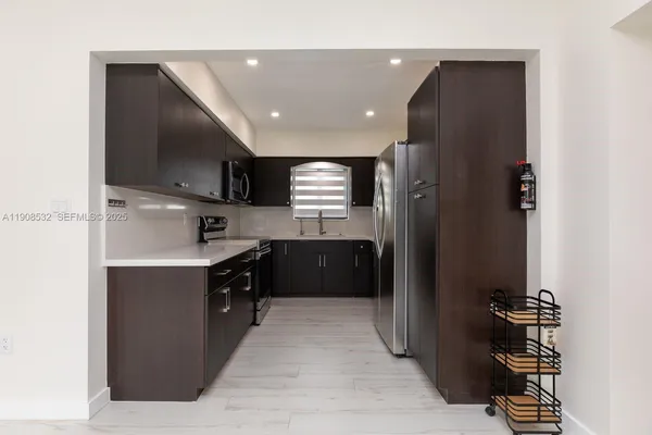 a kitchen with a refrigerator and a sink
