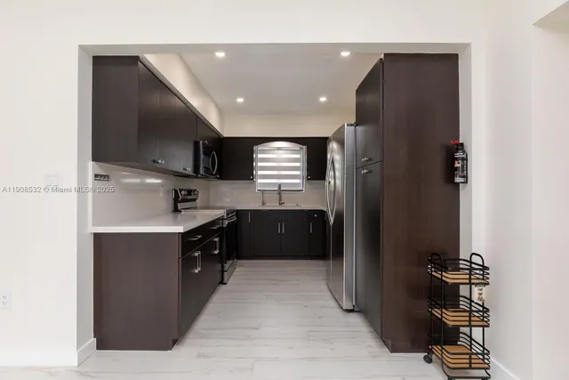 a kitchen with a refrigerator and a sink