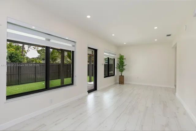 a view of empty room with floor to ceiling window
