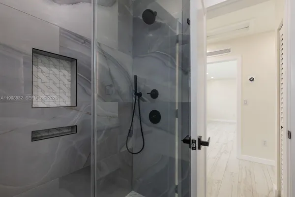 a bathroom with a glass shower door