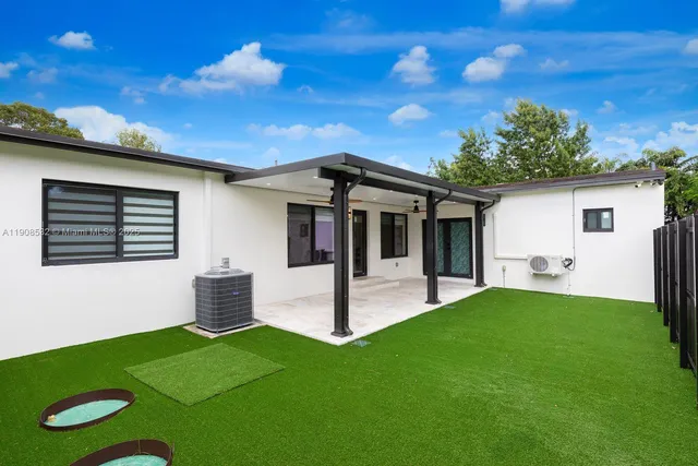 a view of a house with a backyard