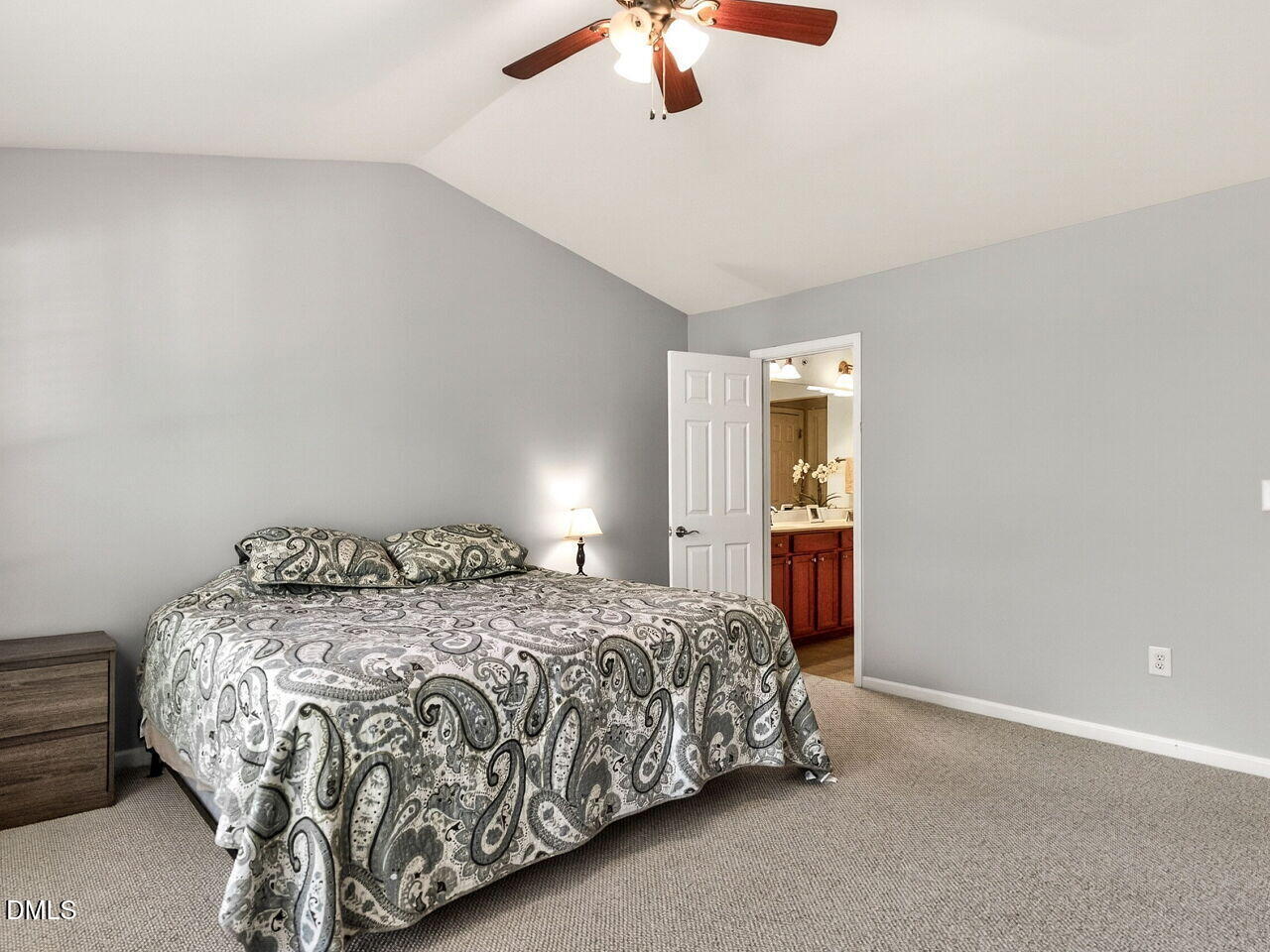 8215 Yaxley Hall Drive Raleigh, NC 27616 - Photo 20 of 42 a bedroom with a bed and a chandelier