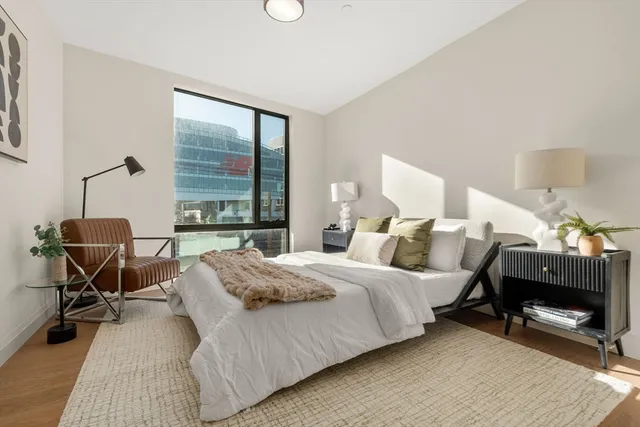 a bedroom with a bed and a desk