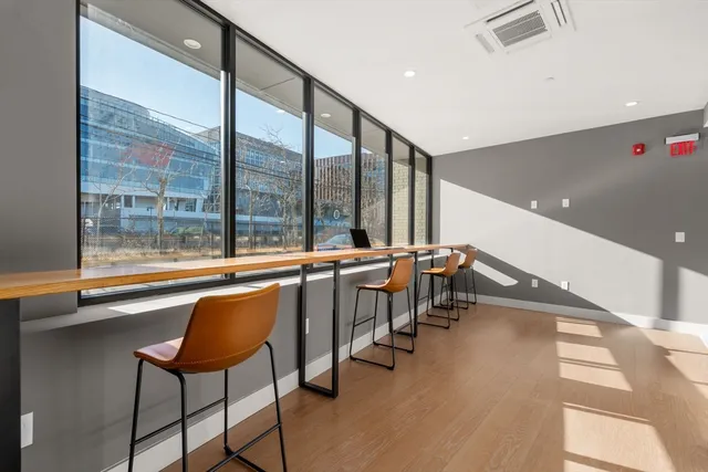 a very nice looking room with a large window and furniture