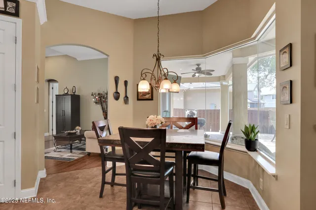 a white bath tub sitting next to a toilet