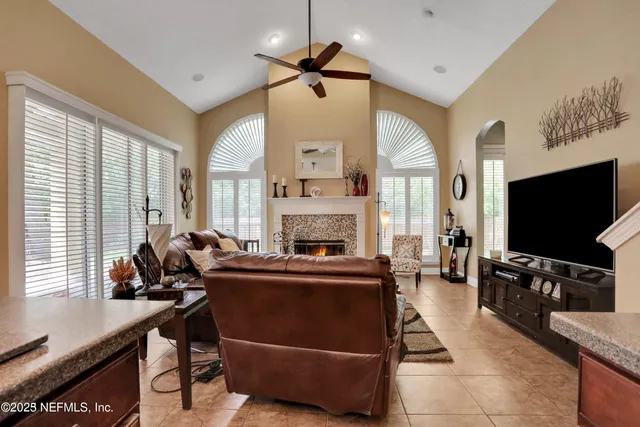 a living room with furniture a fireplace and a flat screen tv