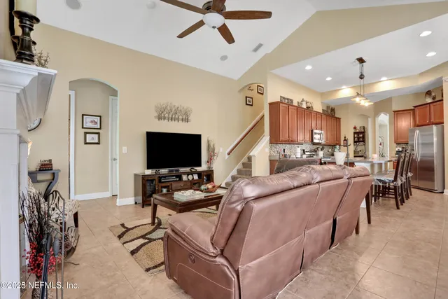 a living room with fireplace furniture and a flat screen tv