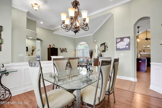 a view of a dining room with furniture and chandelier