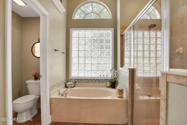 a bathroom with a sink a toilet and shower curtain