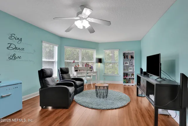 a living room with furniture and a large window
