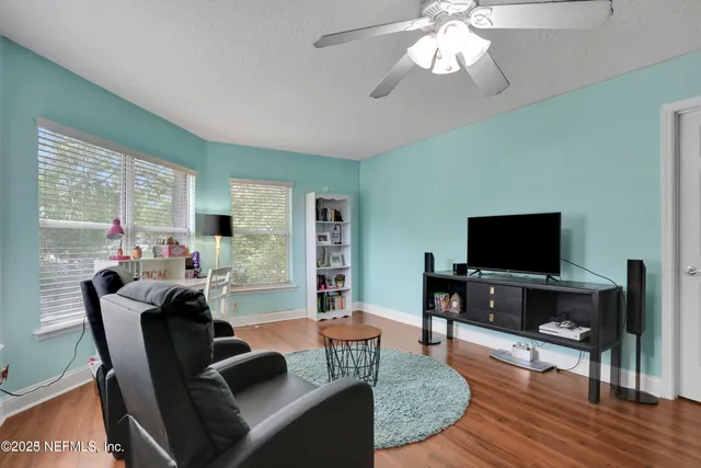 a view of a backyard with wooden fence