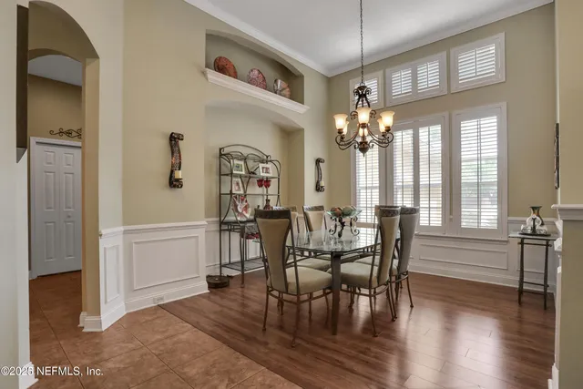 a kitchen with kitchen island granite countertop a sink and a refrigerator