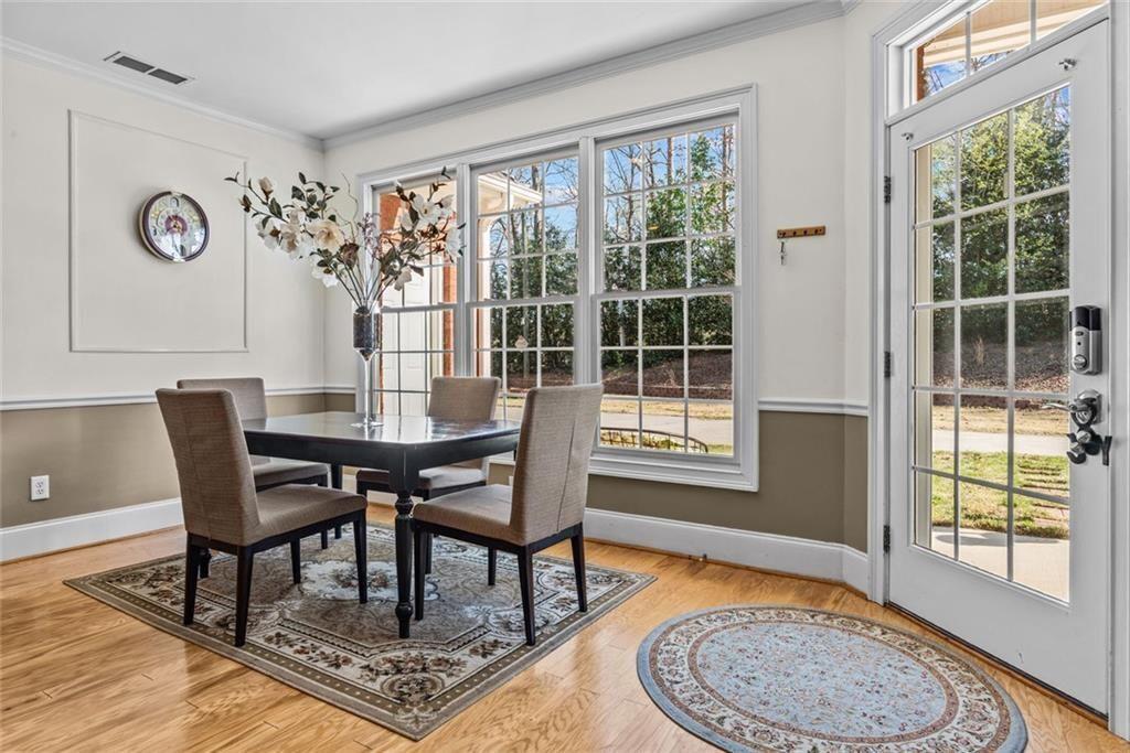 168 Jersey Road Oxford, GA 30054 - Photo 20 of 59 a dining room with furniture wooden floor and a rug
