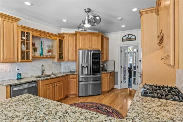 a bedroom with a bed and a flat tv screen on dresser