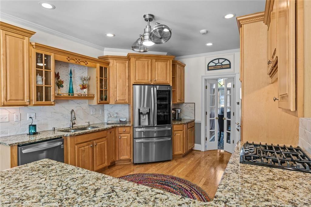 168 Jersey Road Oxford, GA 30054 - Photo 22 of 59 a kitchen with stainless steel appliances granite countertop a sink stove and refrigerator