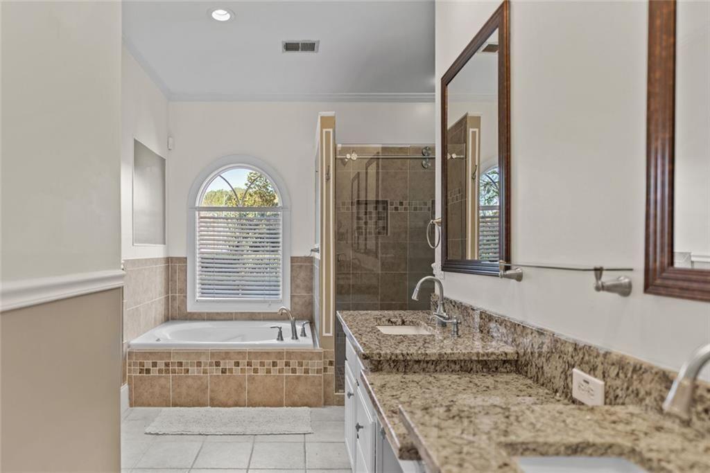 168 Jersey Road Oxford, GA 30054 - Photo 31 of 59 a spacious bathroom with a granite countertop tub sink and mirror
